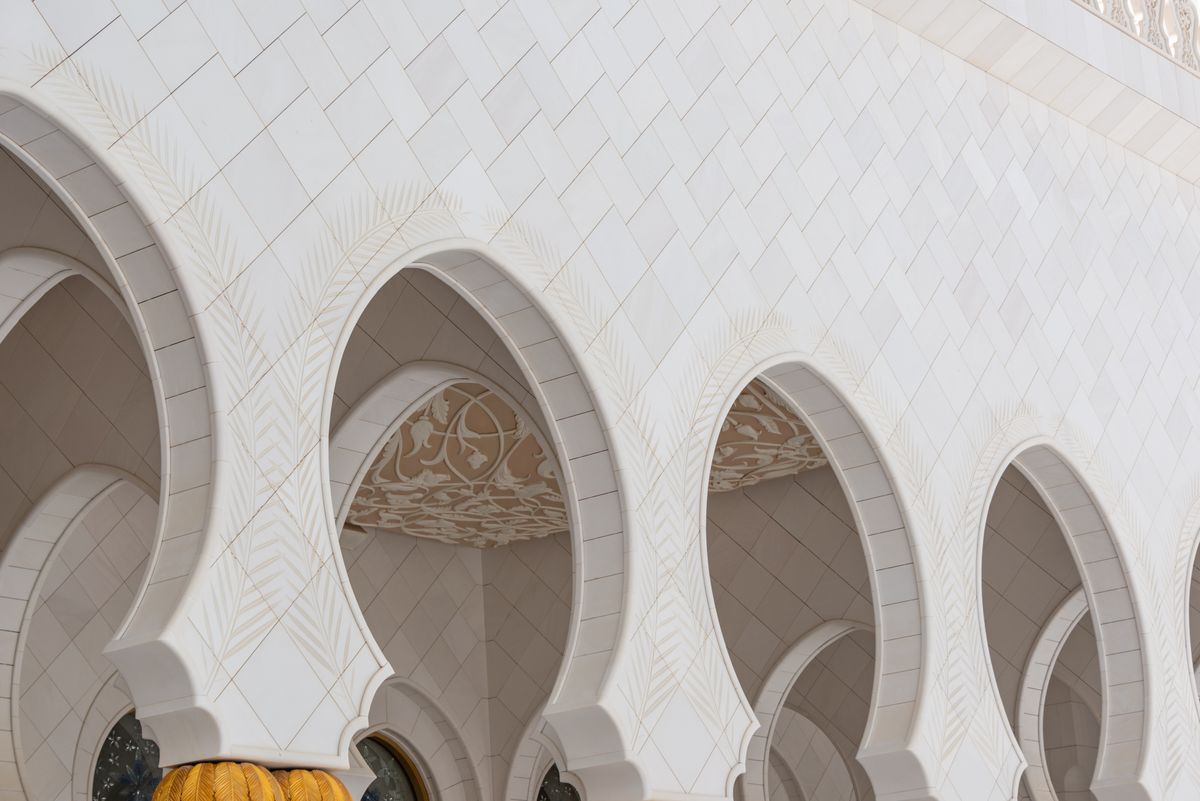 Soft daylight on the sculpted arches of a mosque